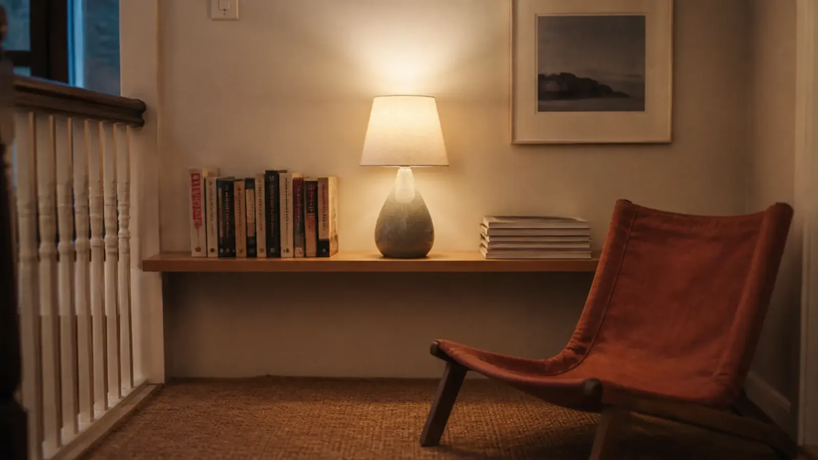 small landing wall with a book shelf and a low reading chair beneath