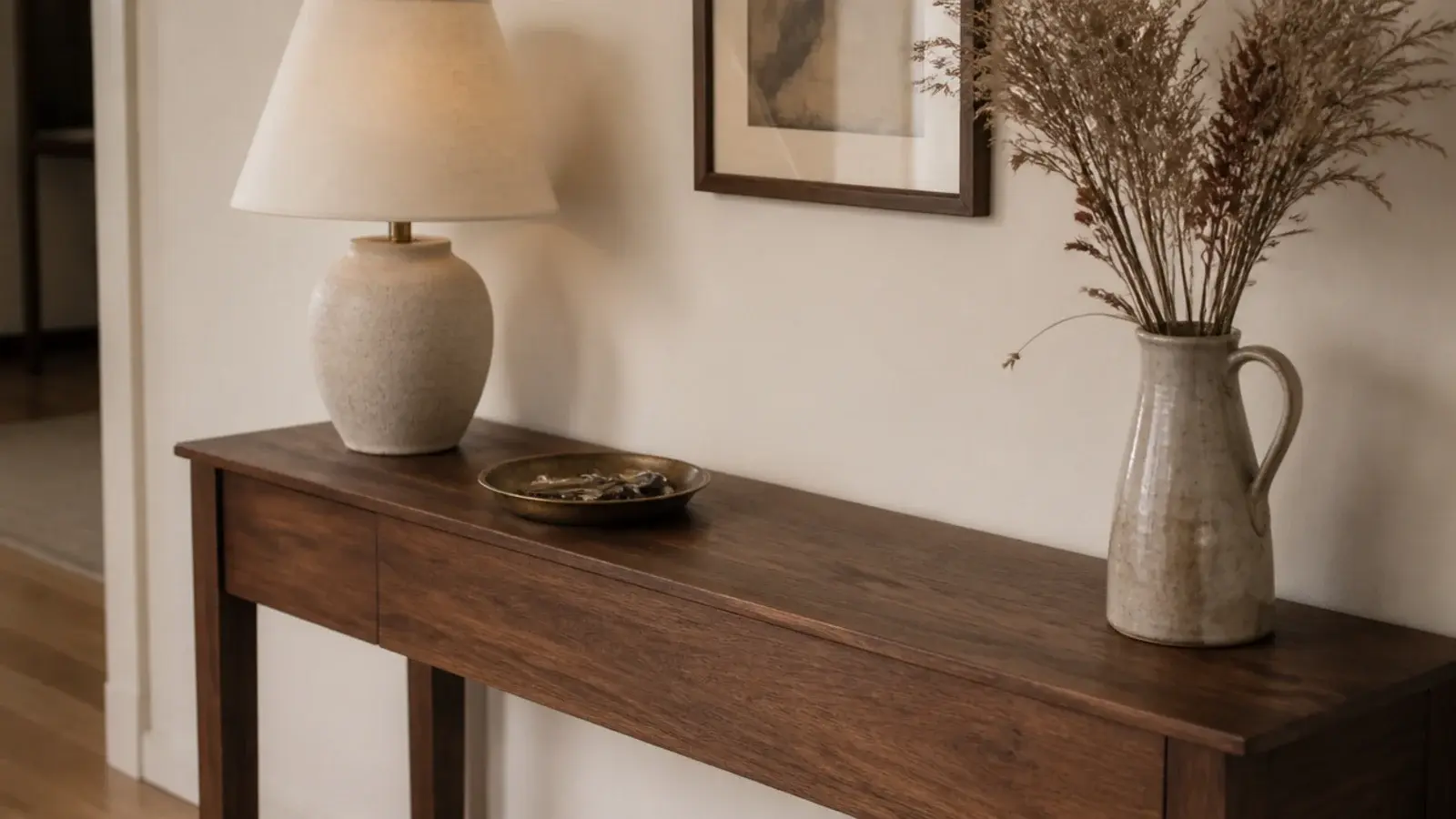 entryway table decor with a stoneware lamp brass tray and dried grasses