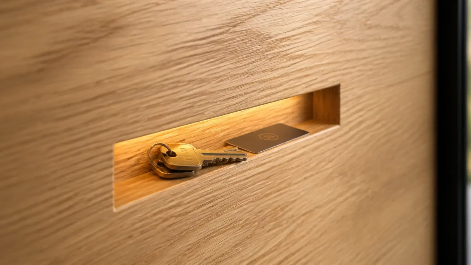 narrow key slot recess cut into a modern entryway oak panel