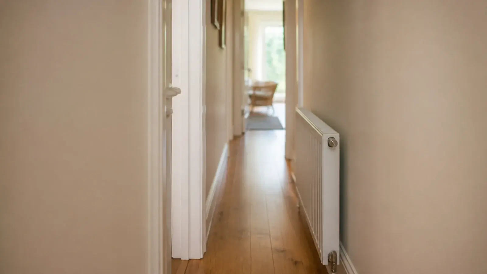 narrow hall measured beside a projecting doorframe and radiator