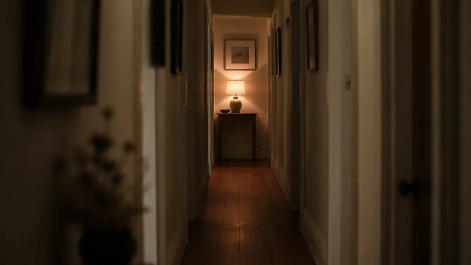 warm light glowing at the far end of a long narrow hallway