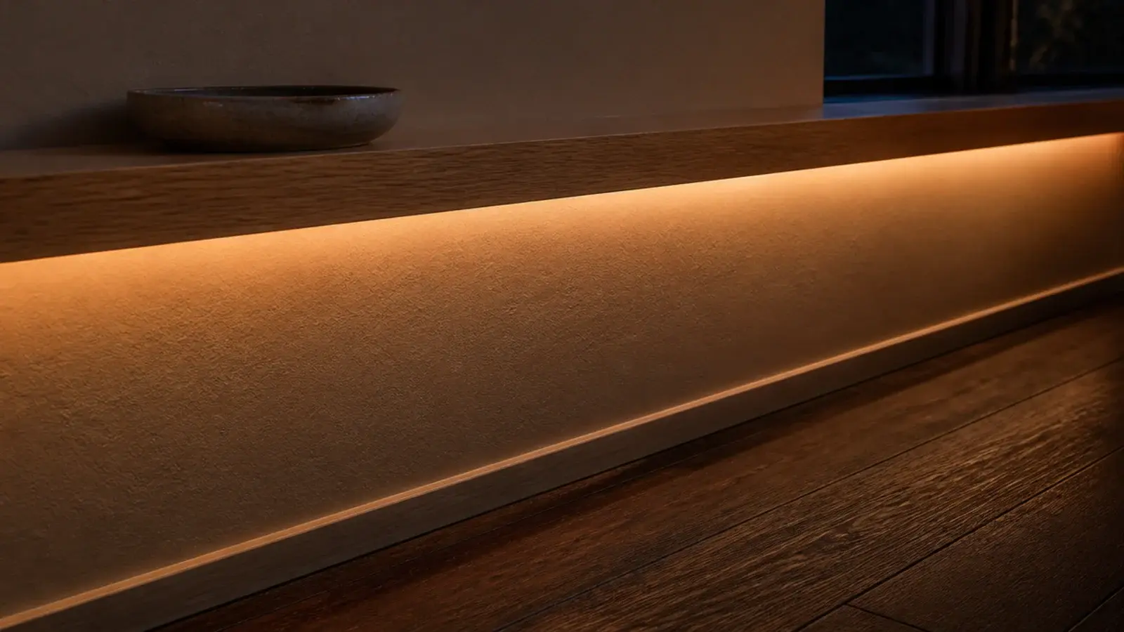 warm led strip glowing beneath a small entryway wall ledge at night