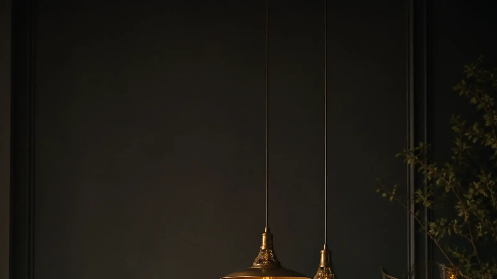 tall view of dining table hanging lights above a laid evening table