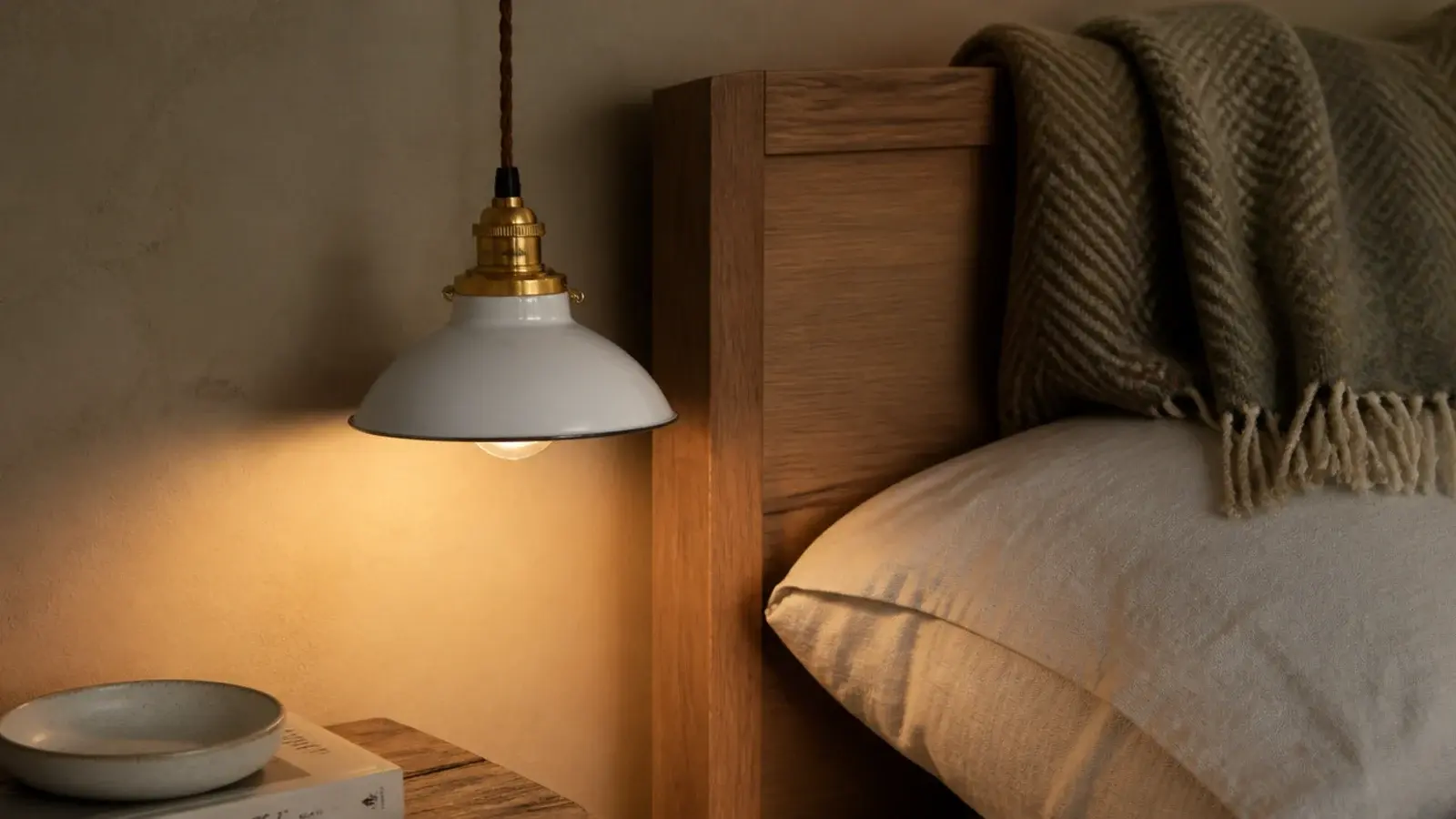 compact shade sized to sit beside a narrow bedroom headboard