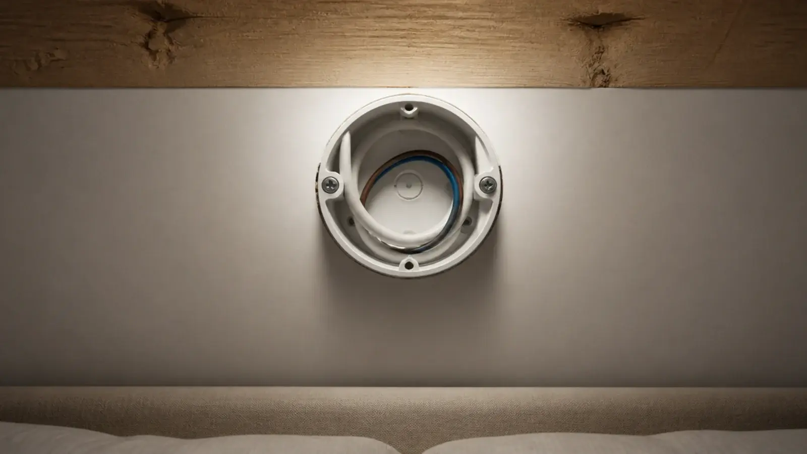 ceiling box exposed above a bed showing its fixing to timber