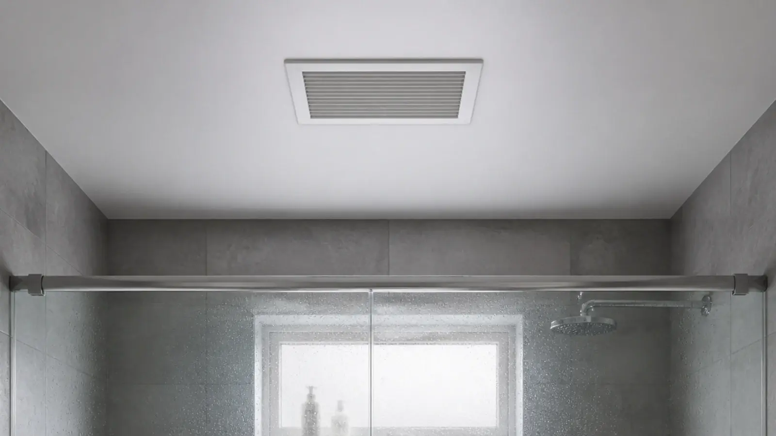 ceiling extractor fan grille above a tiled bathroom shower