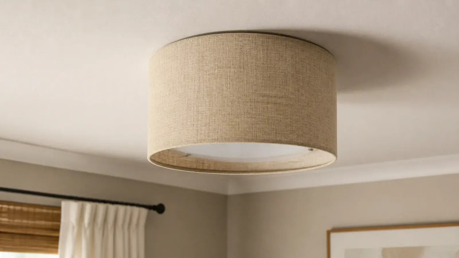 linen drum shade covering a plain builder ceiling light fitting