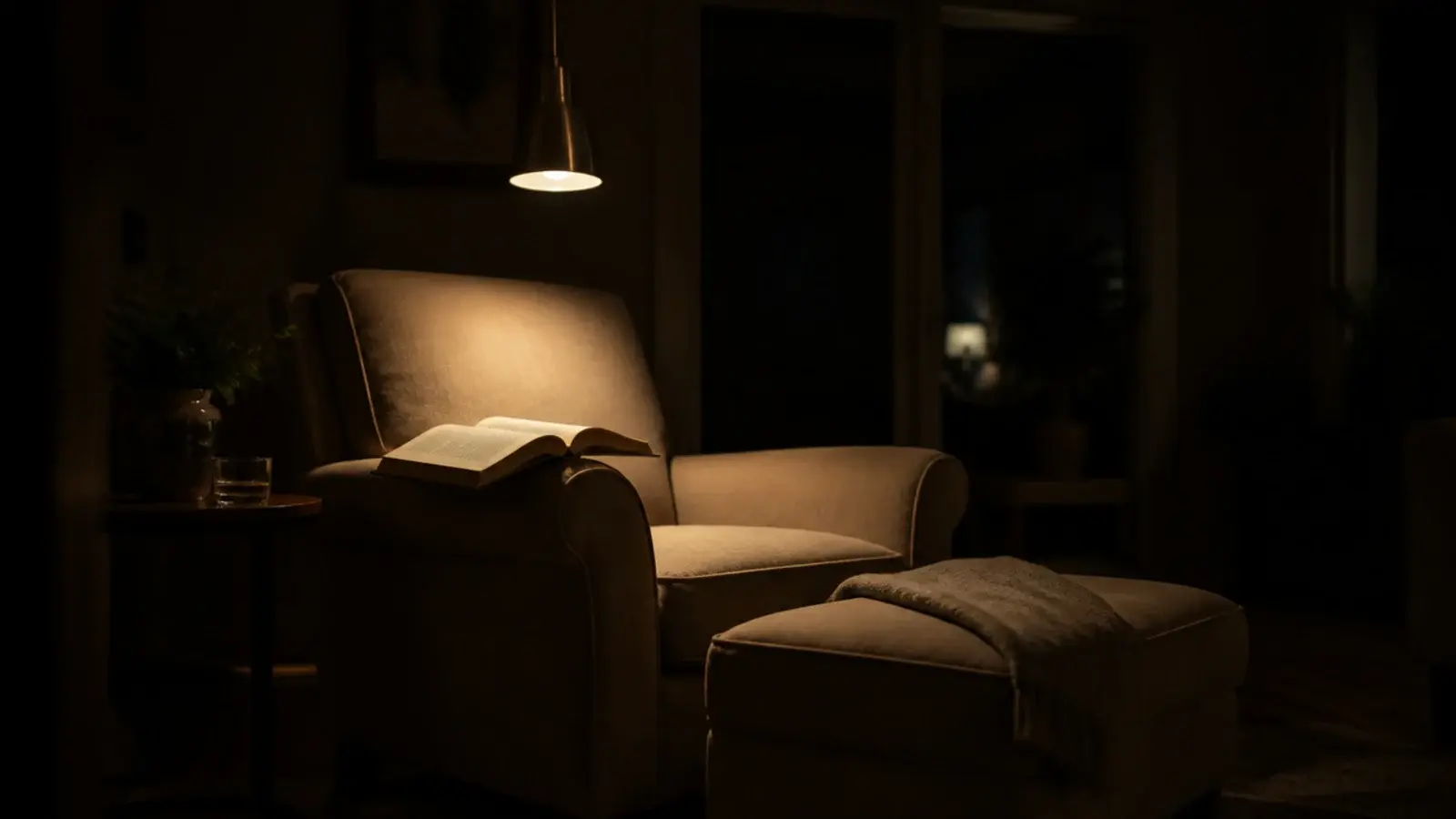 narrow pendant lighting one chair in a dark living room