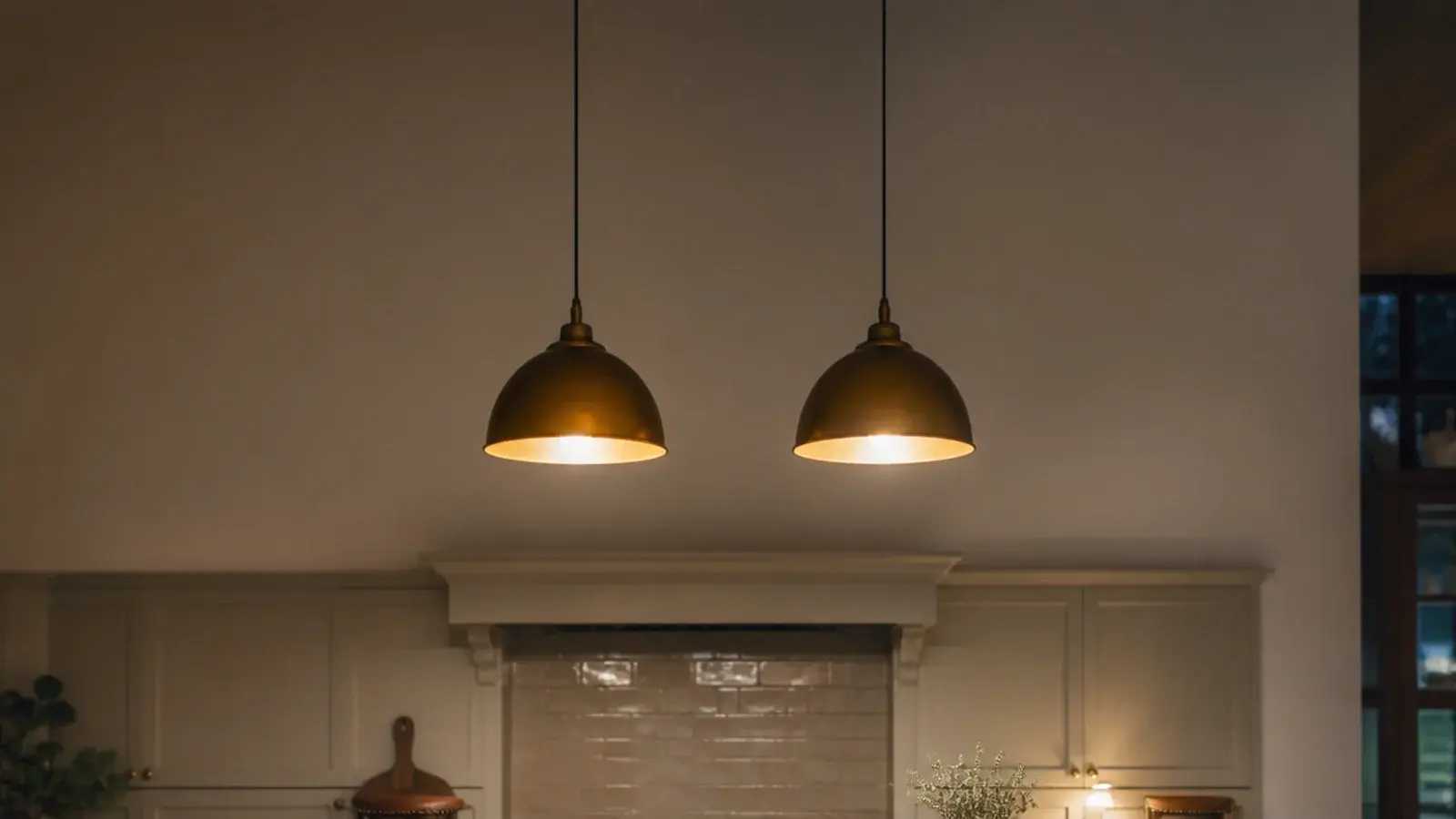 tall kitchen view of hanging lights above a stone island counter