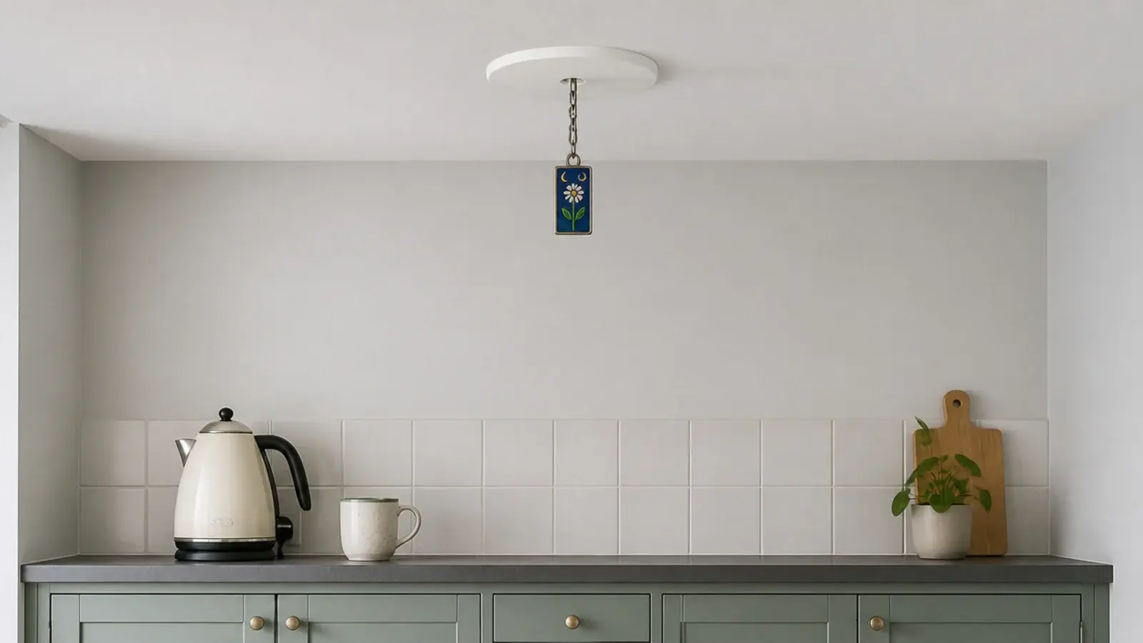 pendant hanging from a converted downlight in a rented kitchen