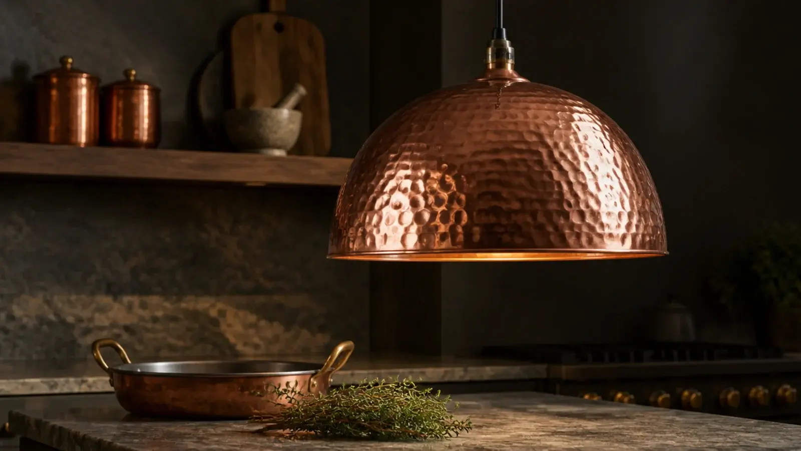 hammered copper dome pendant catching light across its dimples