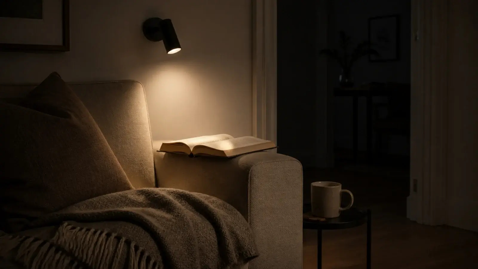 small directional wall light aimed at a sofa reading corner