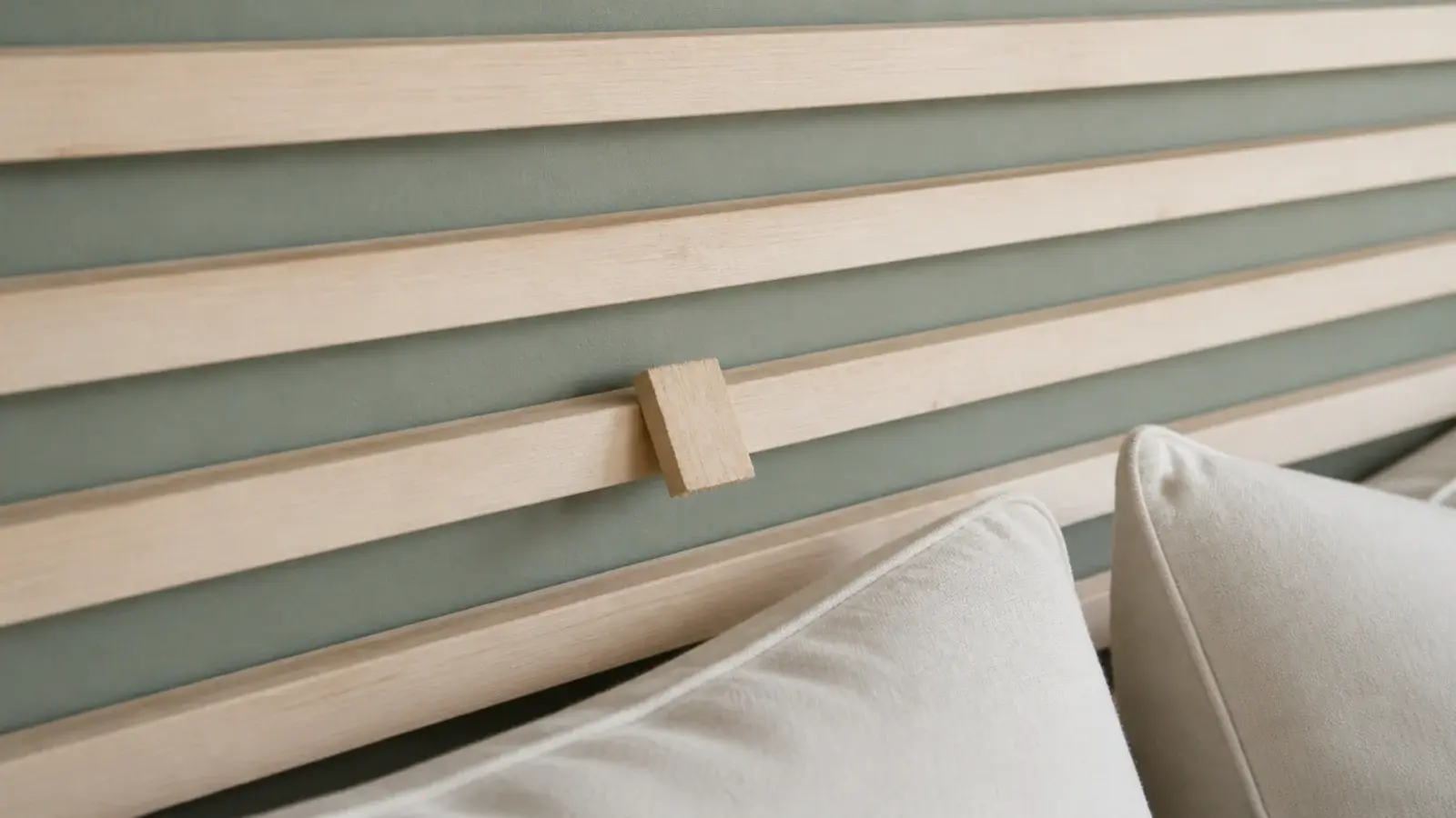 evenly spaced furring strip slats forming a cheap wooden headboard panel