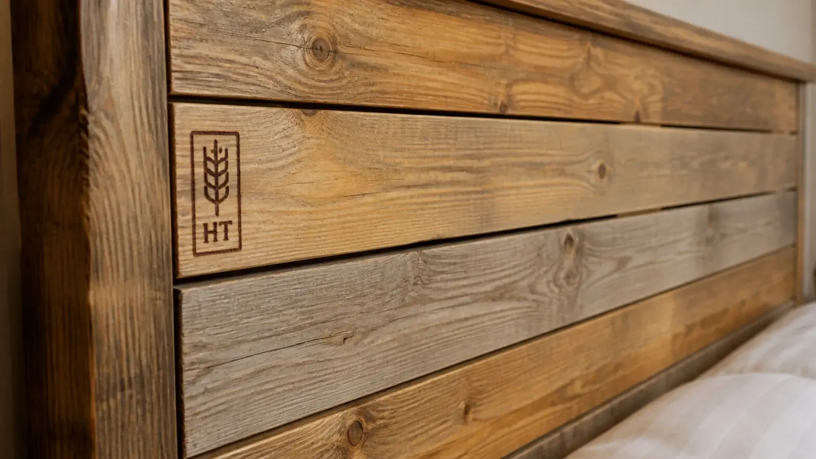 sanded pallet wood headboard with smooth edges and warm honey tones