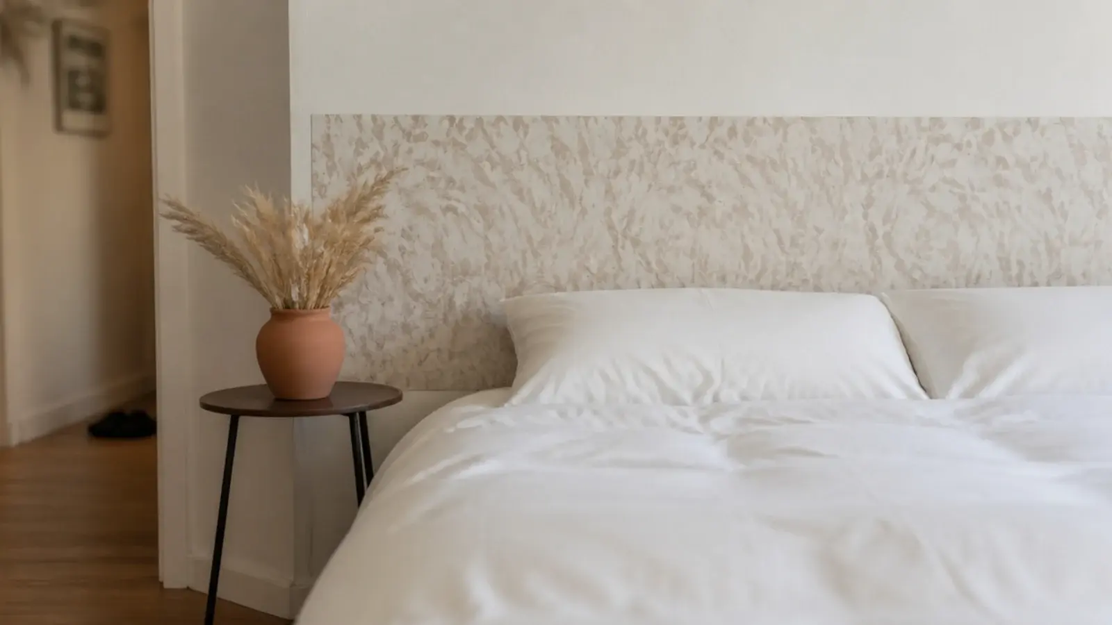 removable patterned wallpaper rectangle behind a bed in a rental bedroom