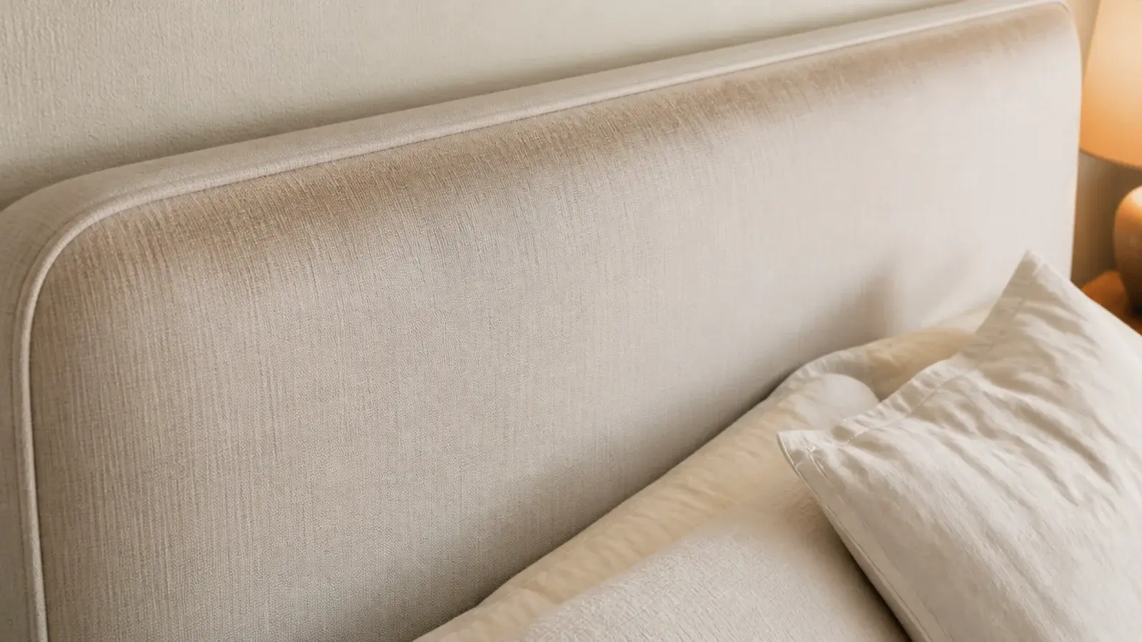 darkened mark along the top edge of a fabric headboard panel