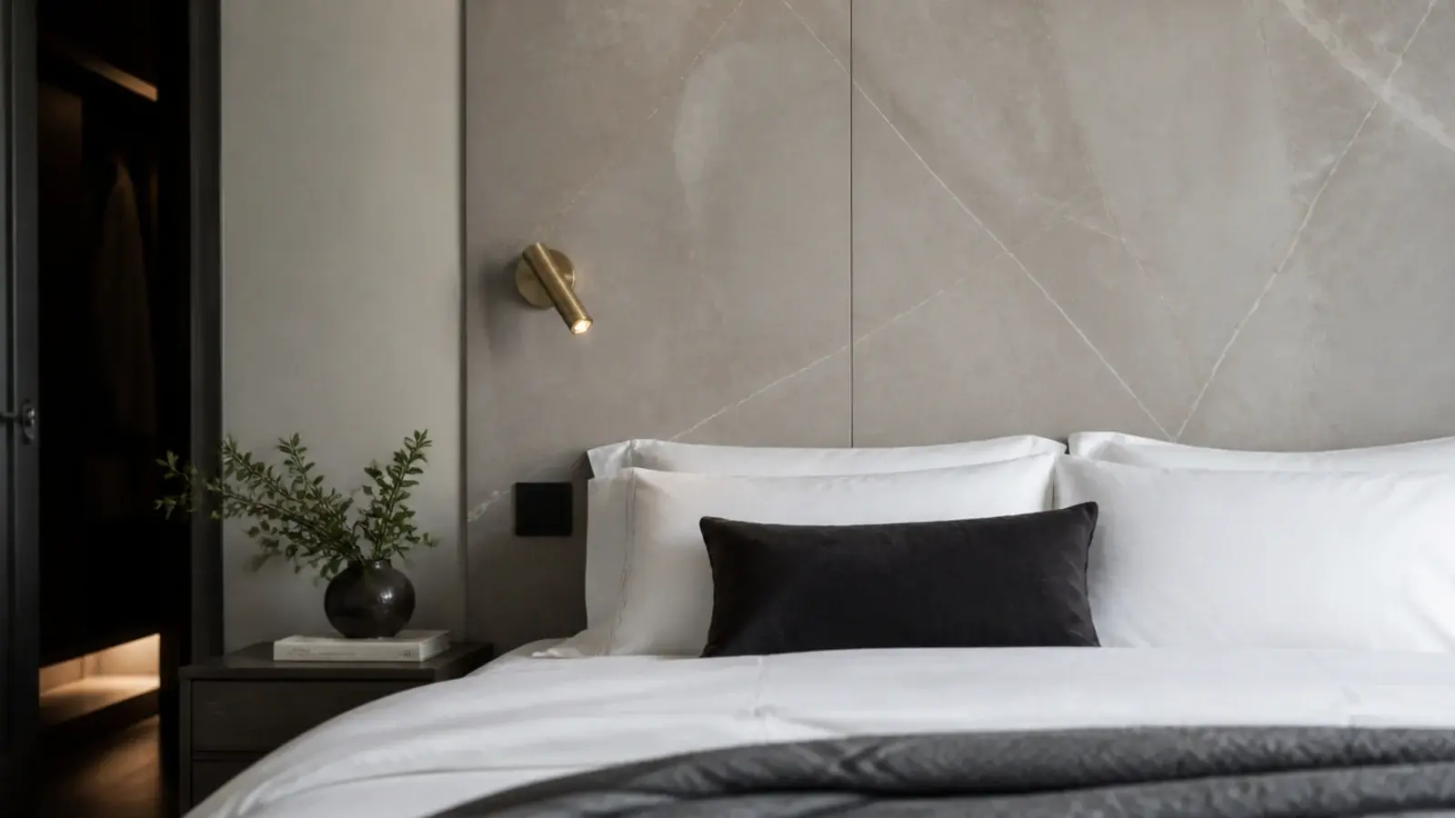large format stone look panel behind a bed with soft veining and matte finish
