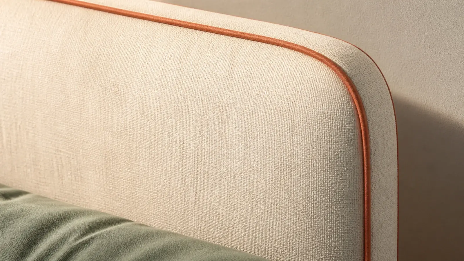 plain linen headboard outlined with contrasting clay piping along every edge