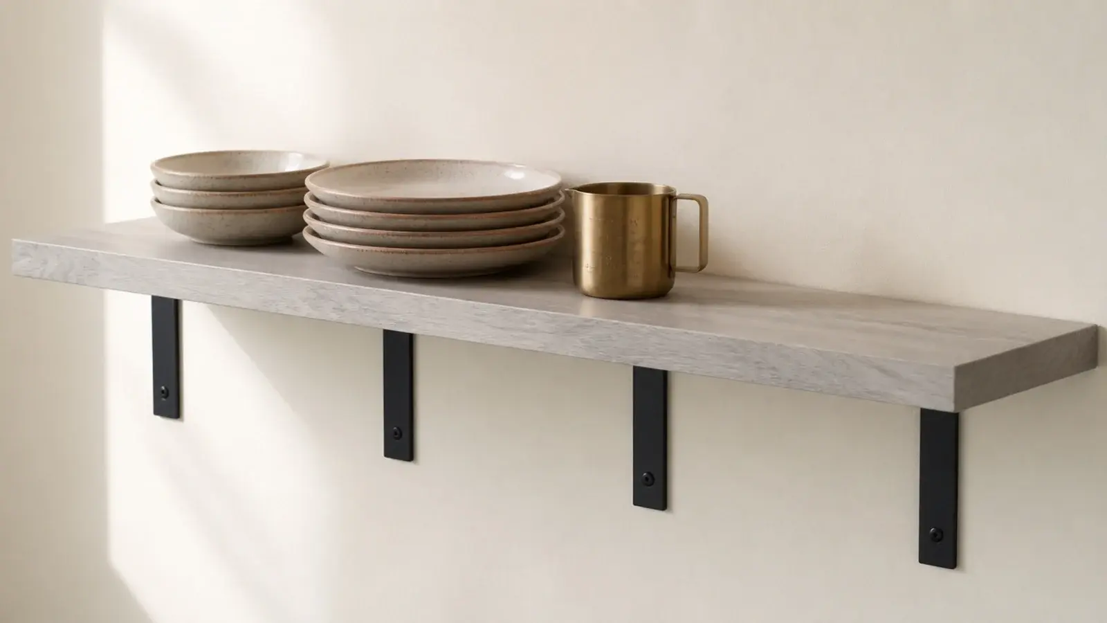 black powder coated L brackets supporting a pale kitchen wall shelf