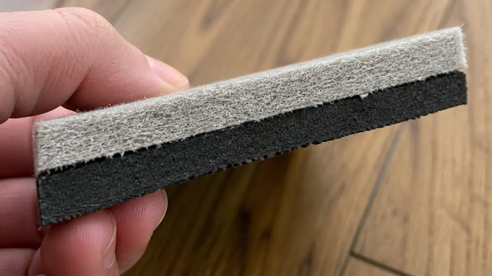 cross section of a felt and rubber pad held up against daylight