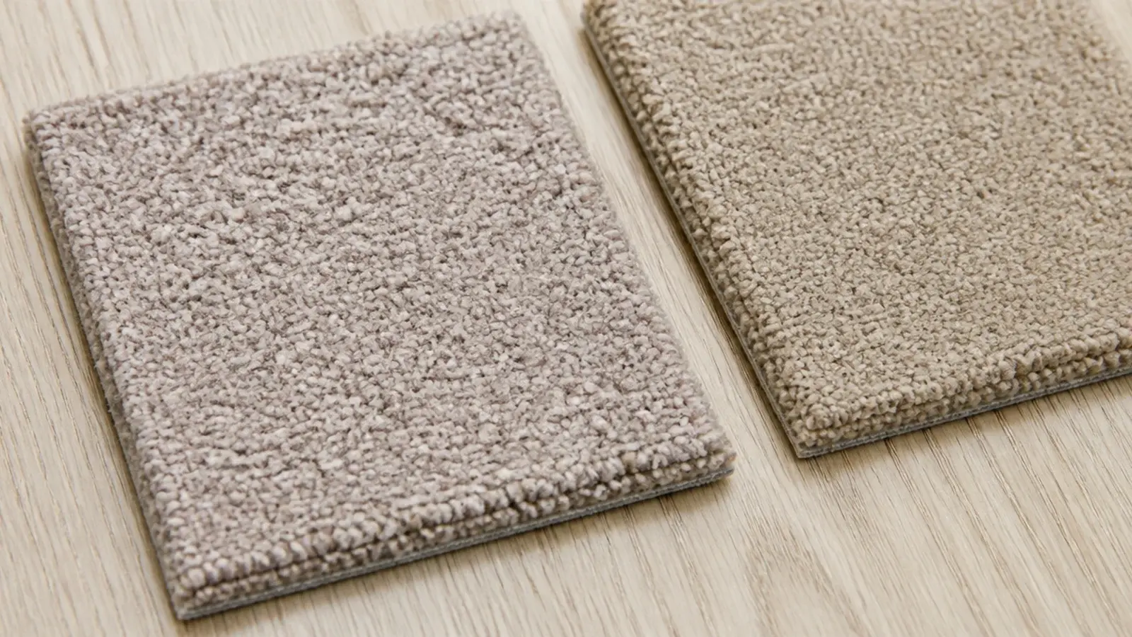 greige rug swatch reading pink against warm timber floorboards
