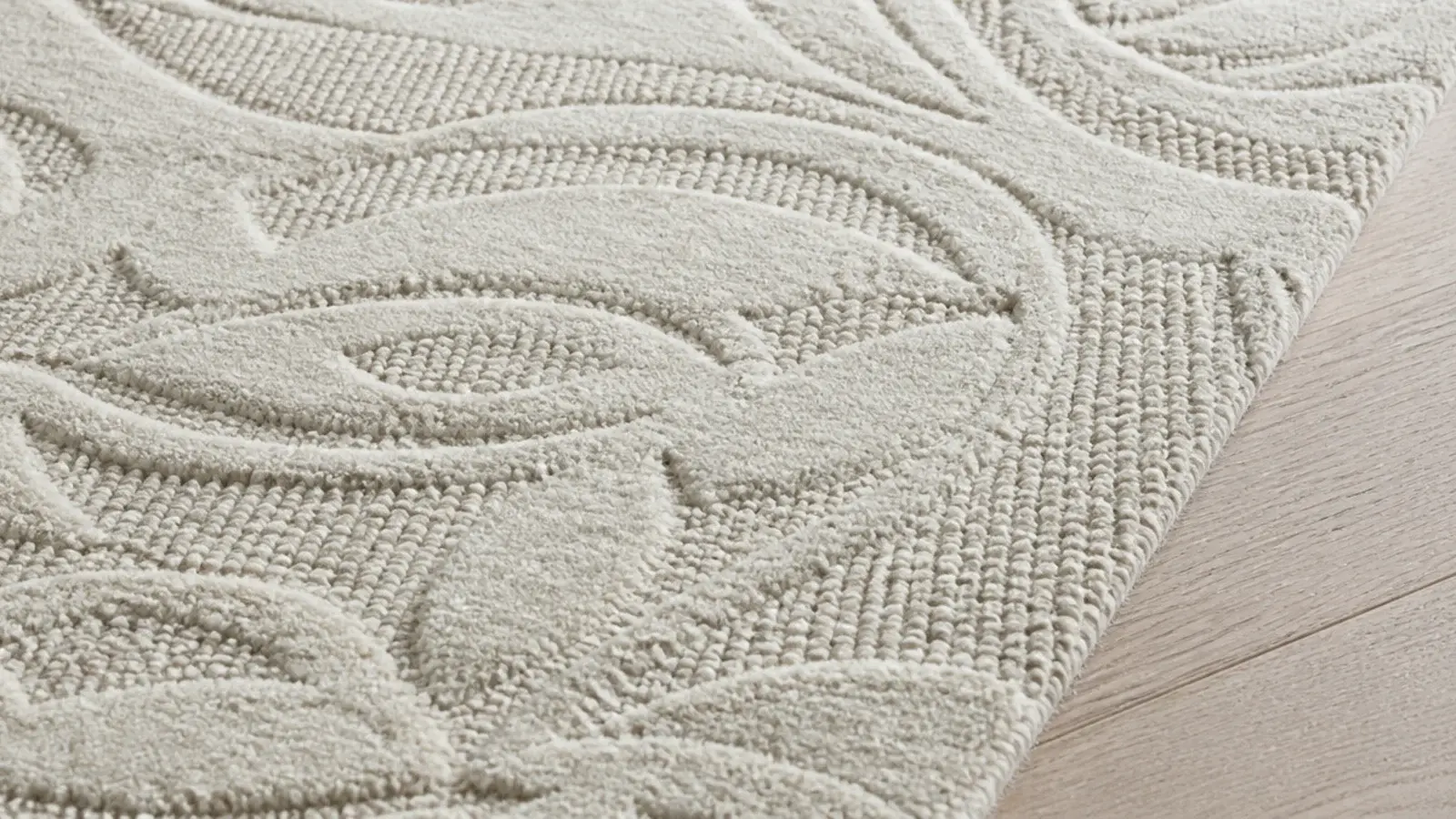 carved high low wool rug throwing soft shadows across its surface