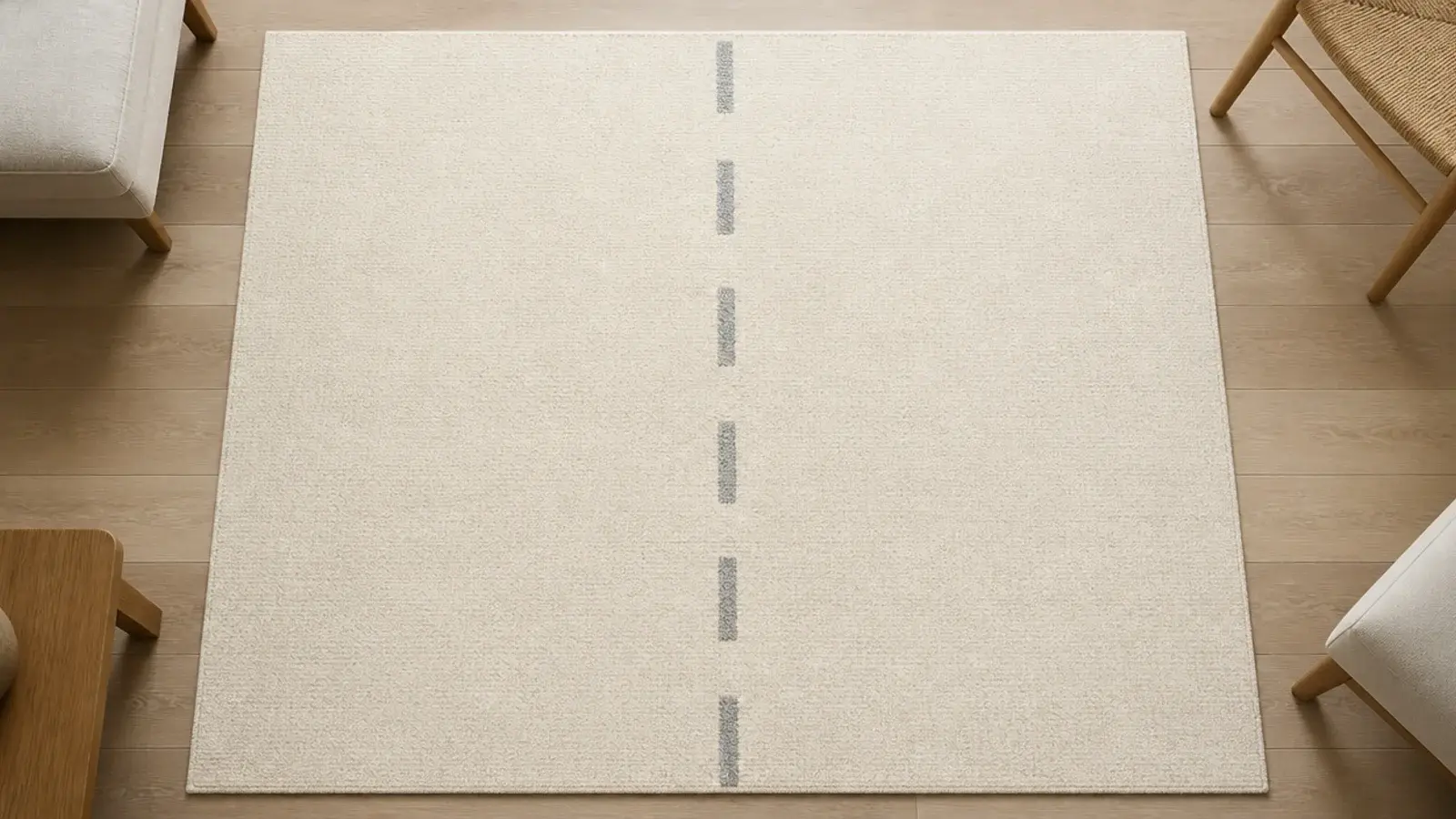 faint darkened traffic lane crossing a plain cream living room rug