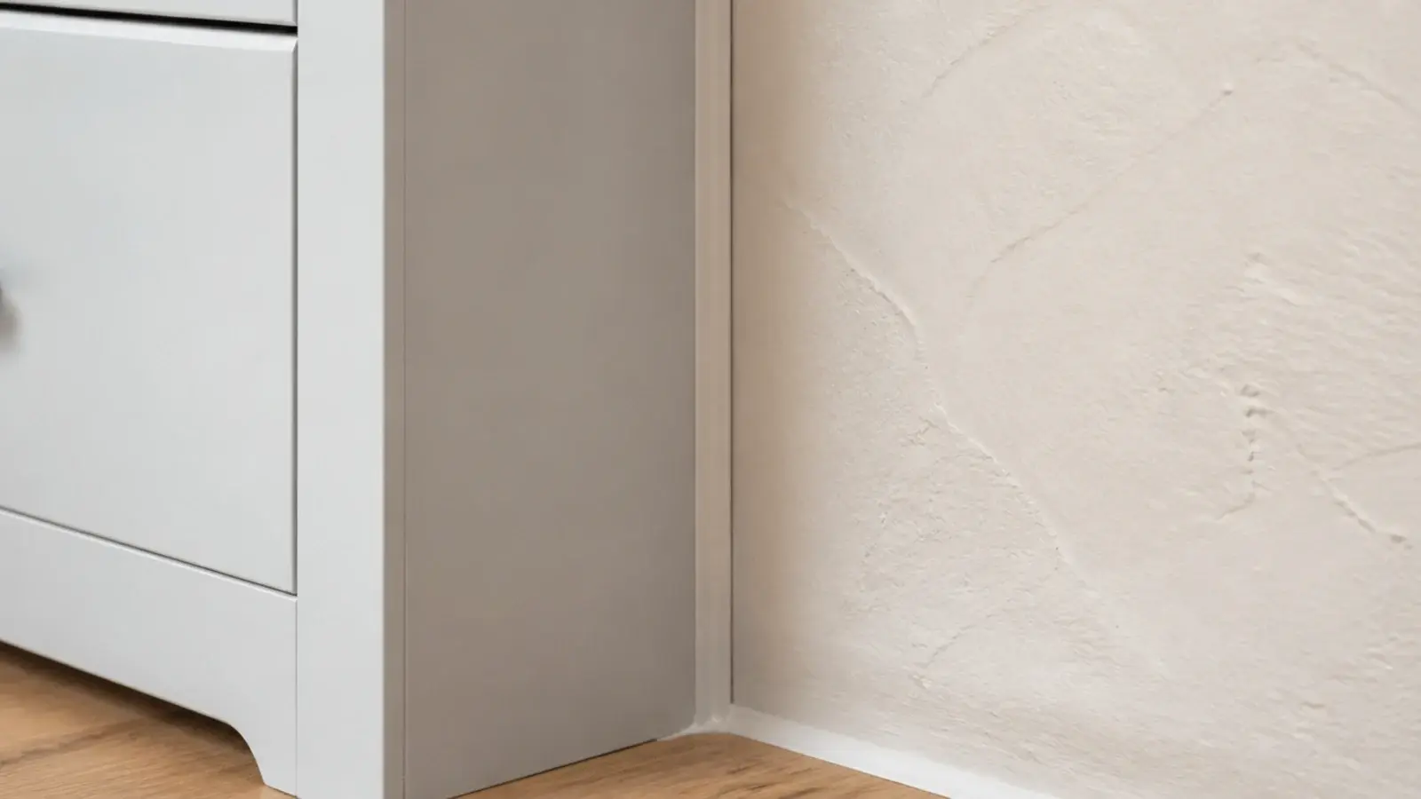 thin scribe trim closing the gap between a shoe cabinet and wall