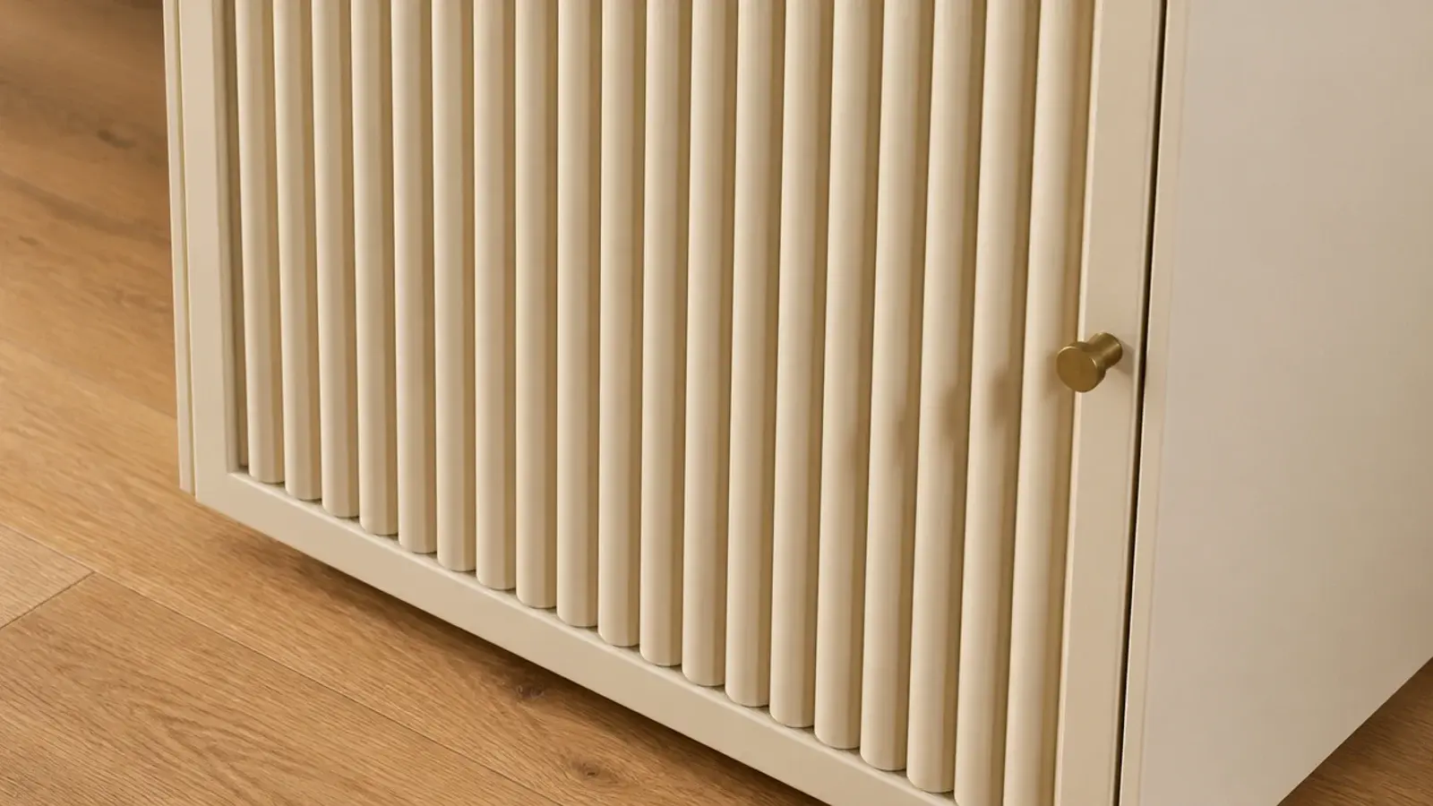 fluted vertical dowel front on a modern shoe cabinet in a warm hallway