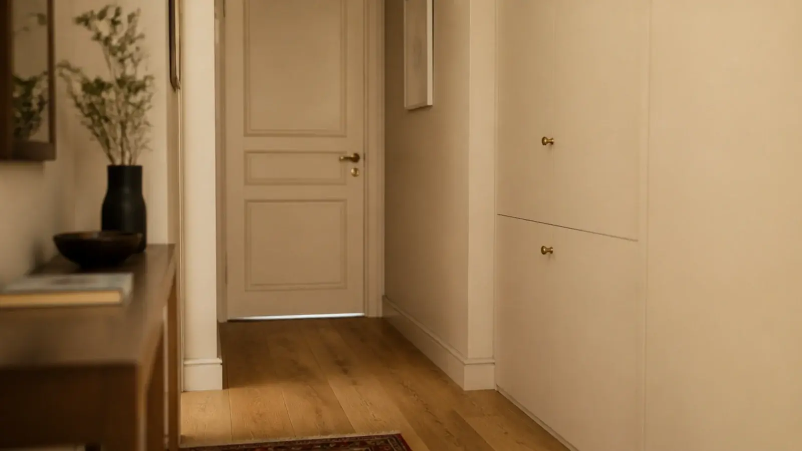 shoe cabinet painted the wall color disappearing into a cream hallway