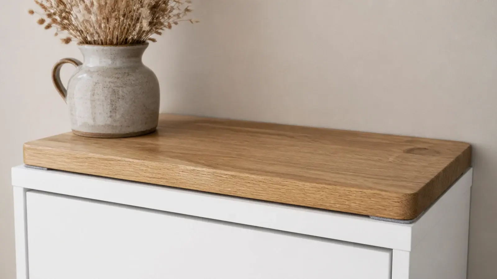 solid oak board resting loose on top of a laminate shoe cabinet