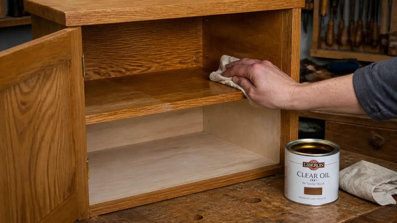 oil being applied to the internal shelves of a wooden shoe cabinet