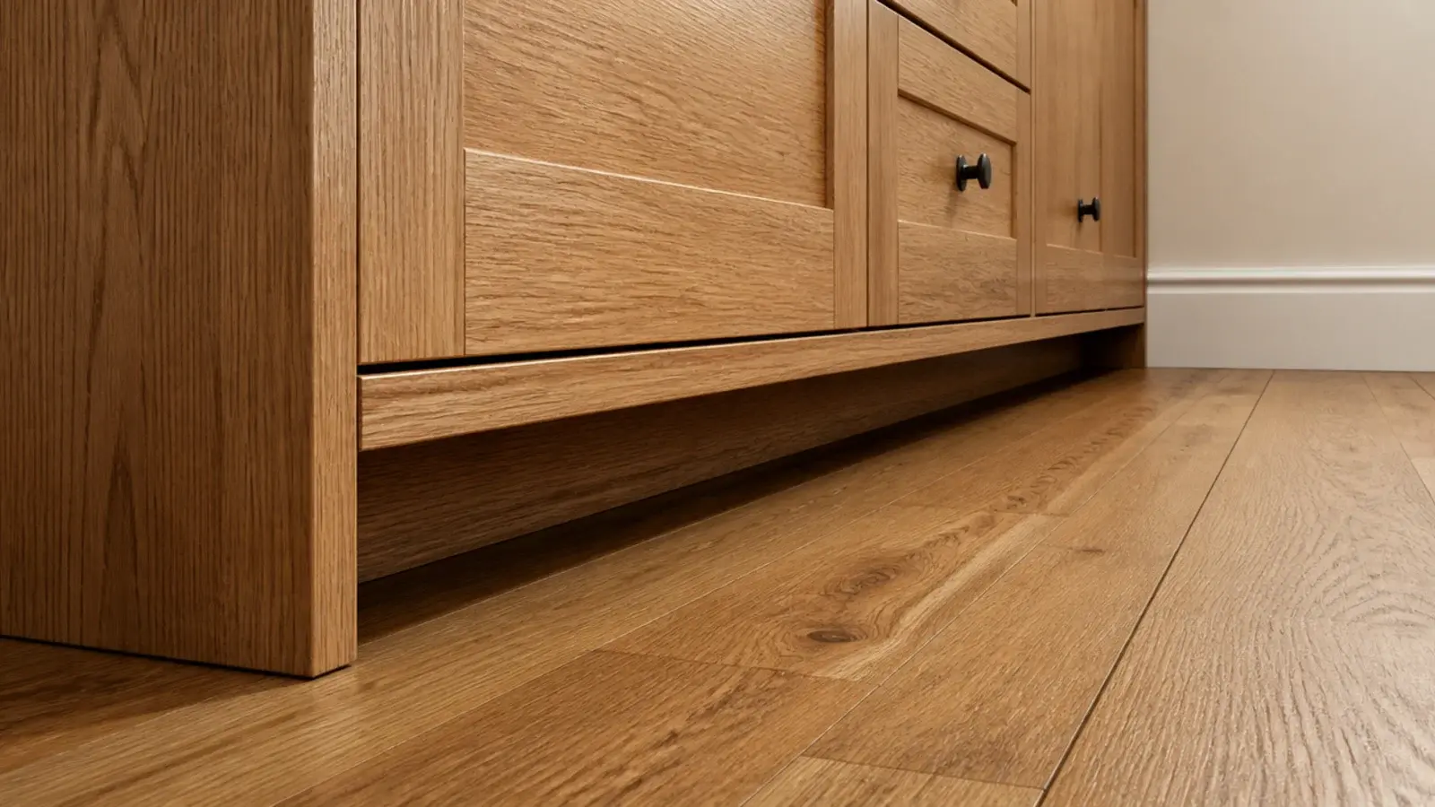 recessed timber toe kick beneath a solid wooden shoe cabinet