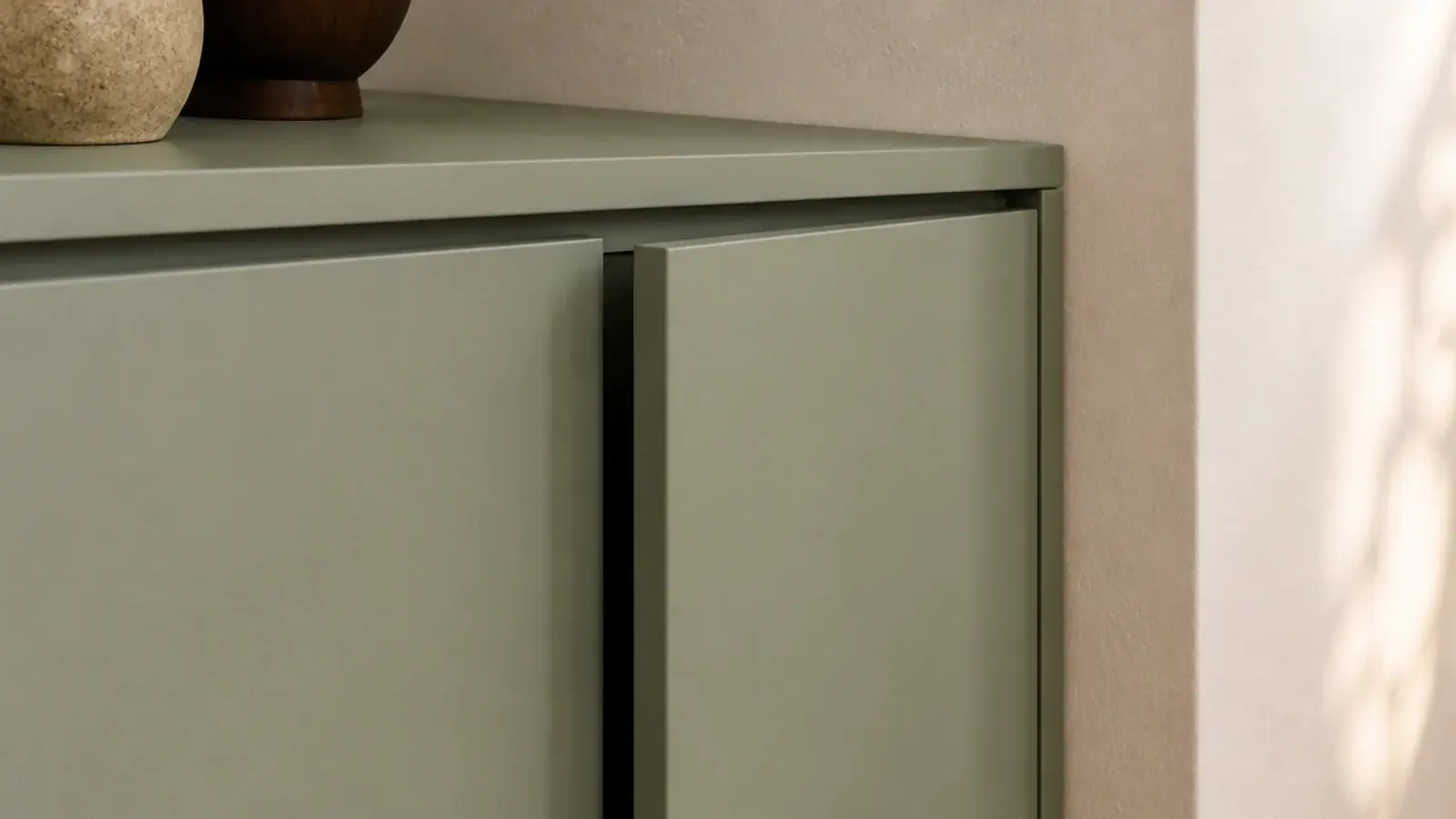 handleless shoe cabinet with a push latch front in a calm entryway