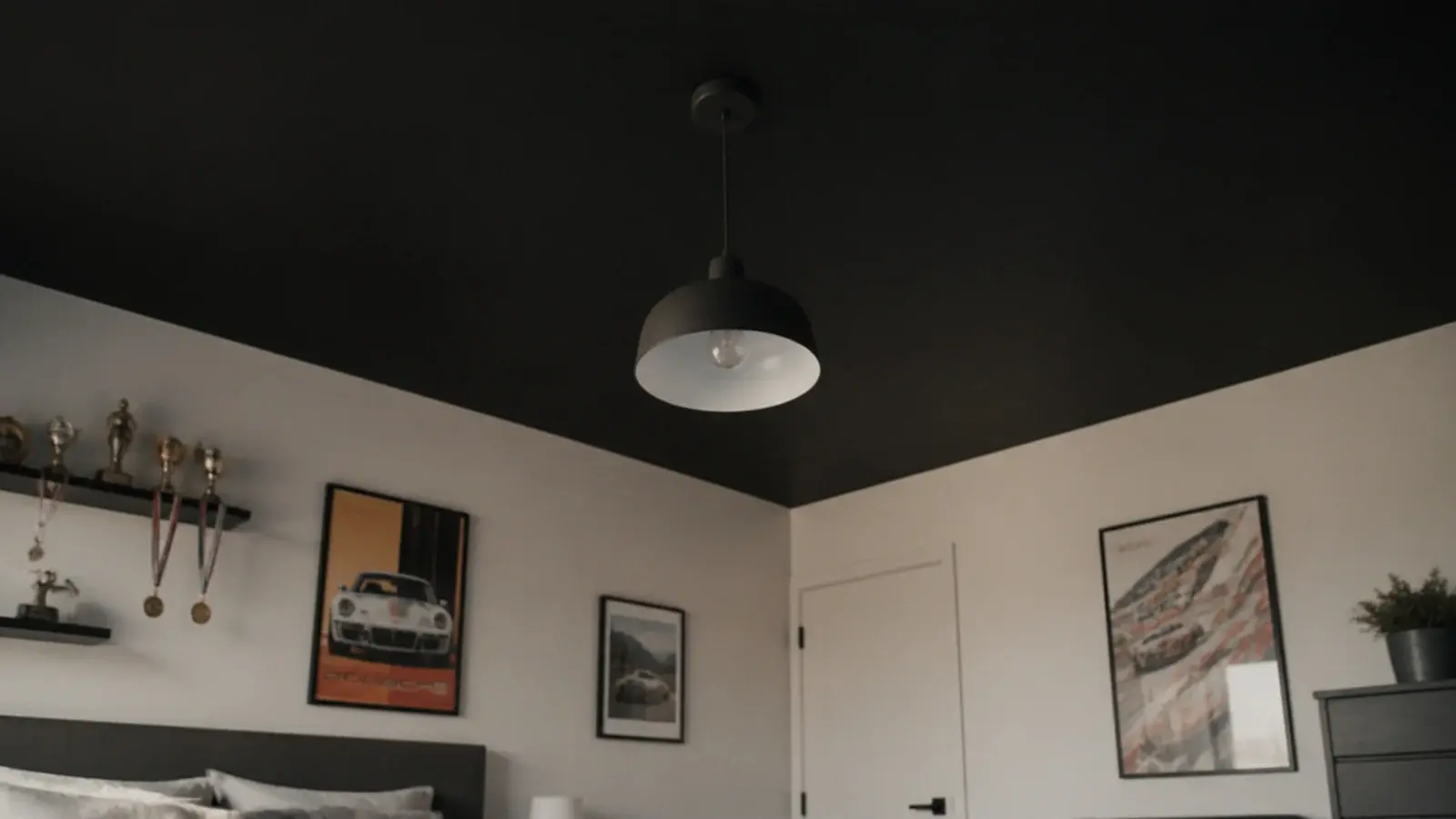 off black painted ceiling above pale walls in a teenage bedroom