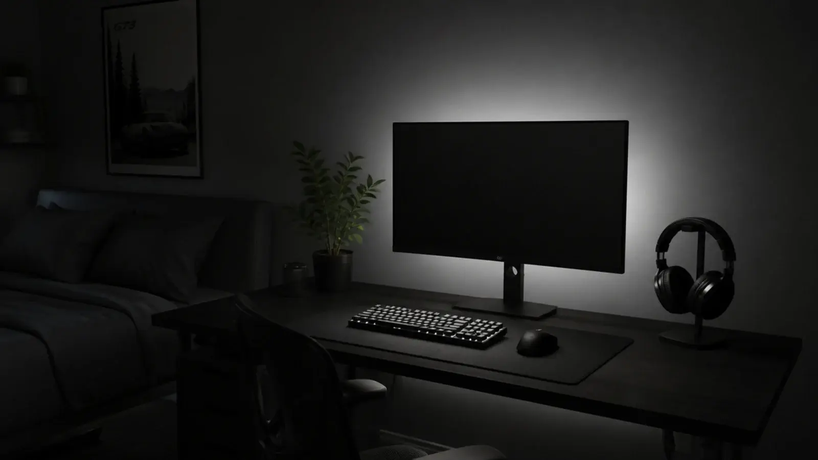even neutral glow behind a monitor washing a dark bedroom wall