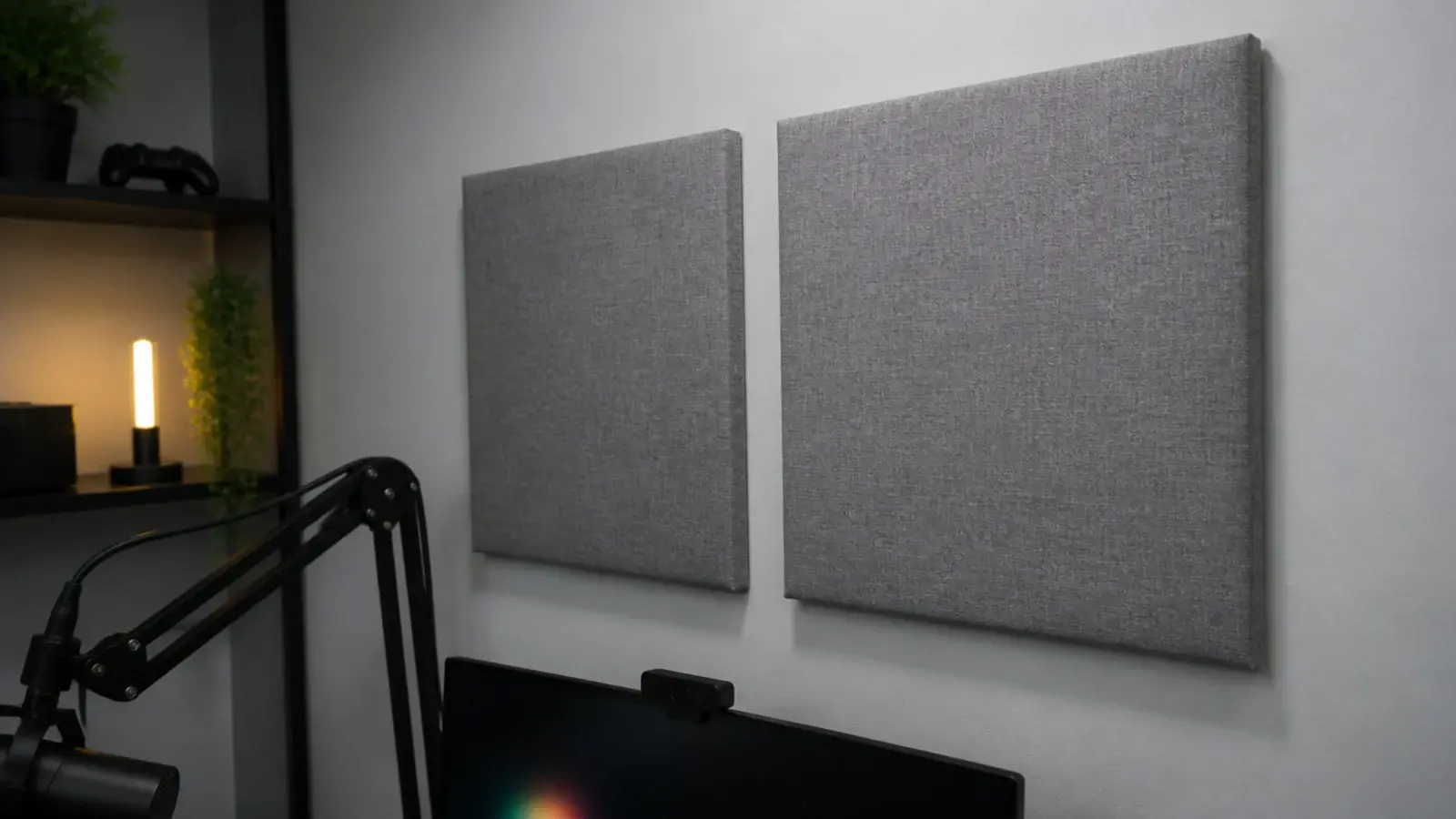 fabric acoustic panels mounted either side of a gaming desk