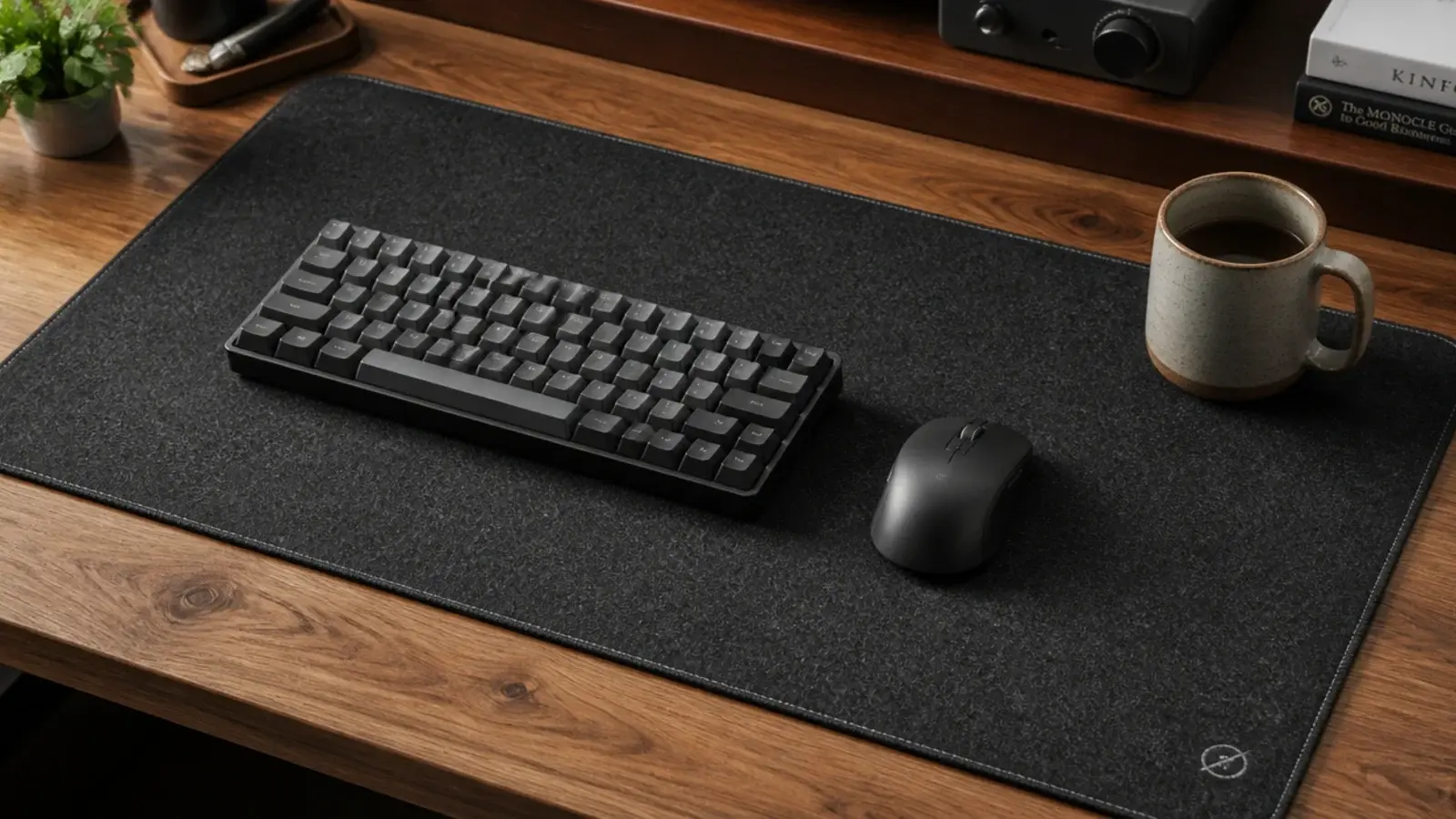 large stitched edge desk mat beneath a keyboard mouse and mug