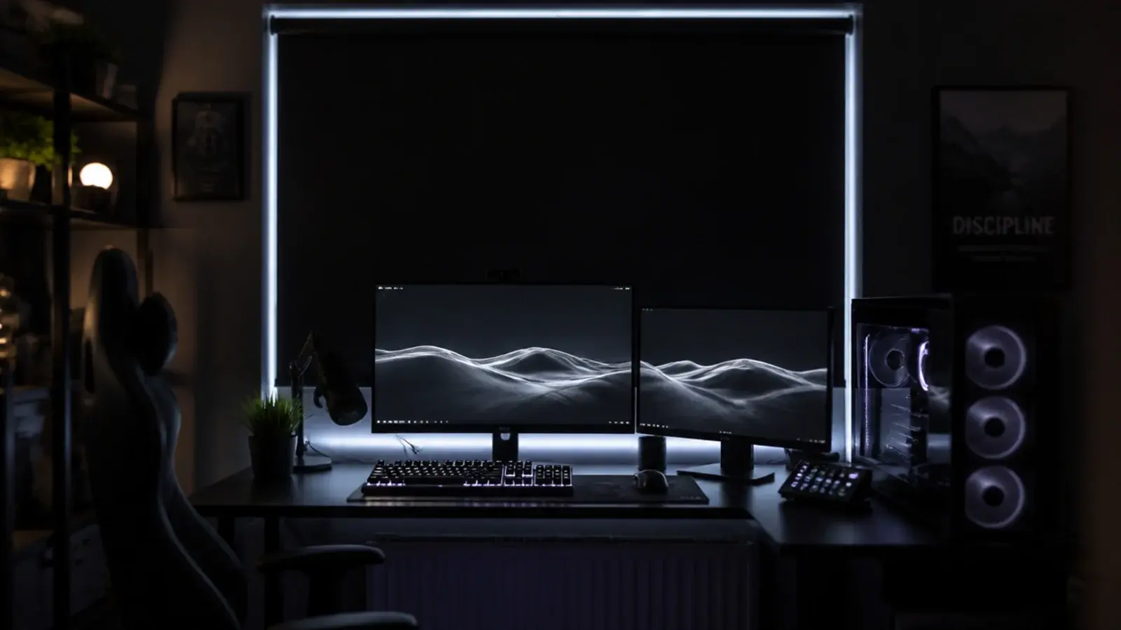 blackout blind fully drawn behind a lit gaming desk at midday