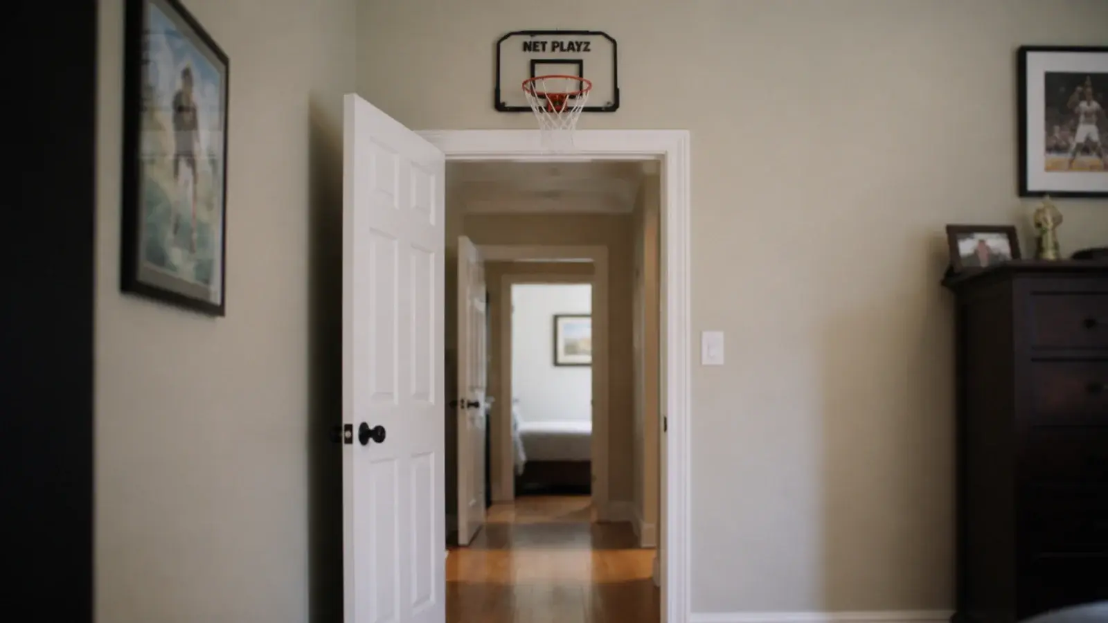 mini basketball hoop screwed above a door frame with clear floor