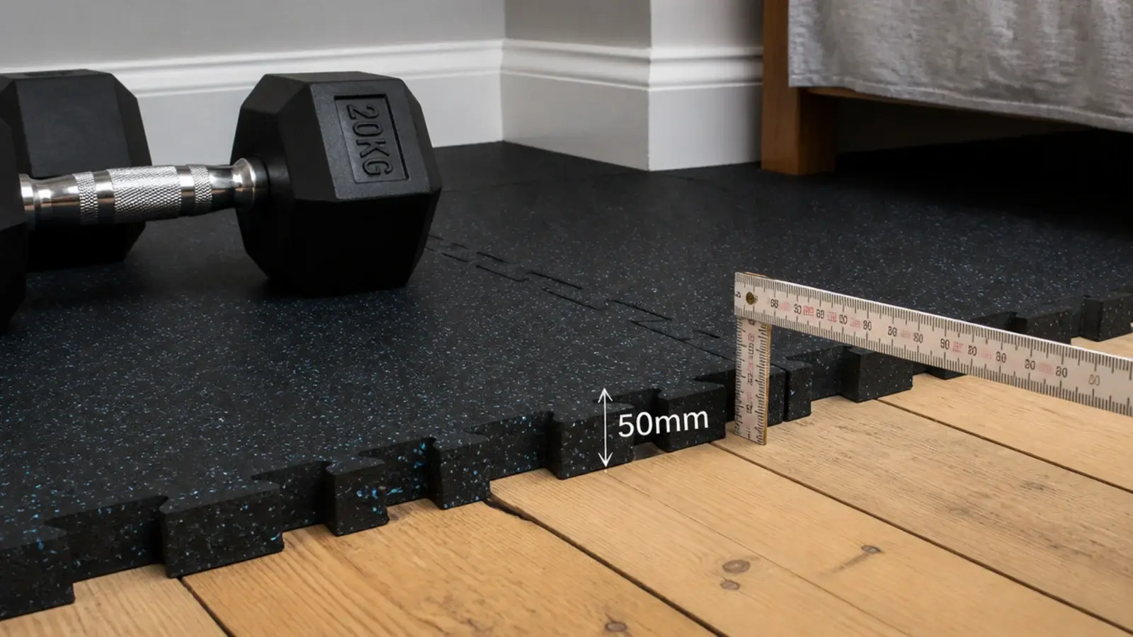 rubber floor tiles laid in a corner beside a timber bedroom floor