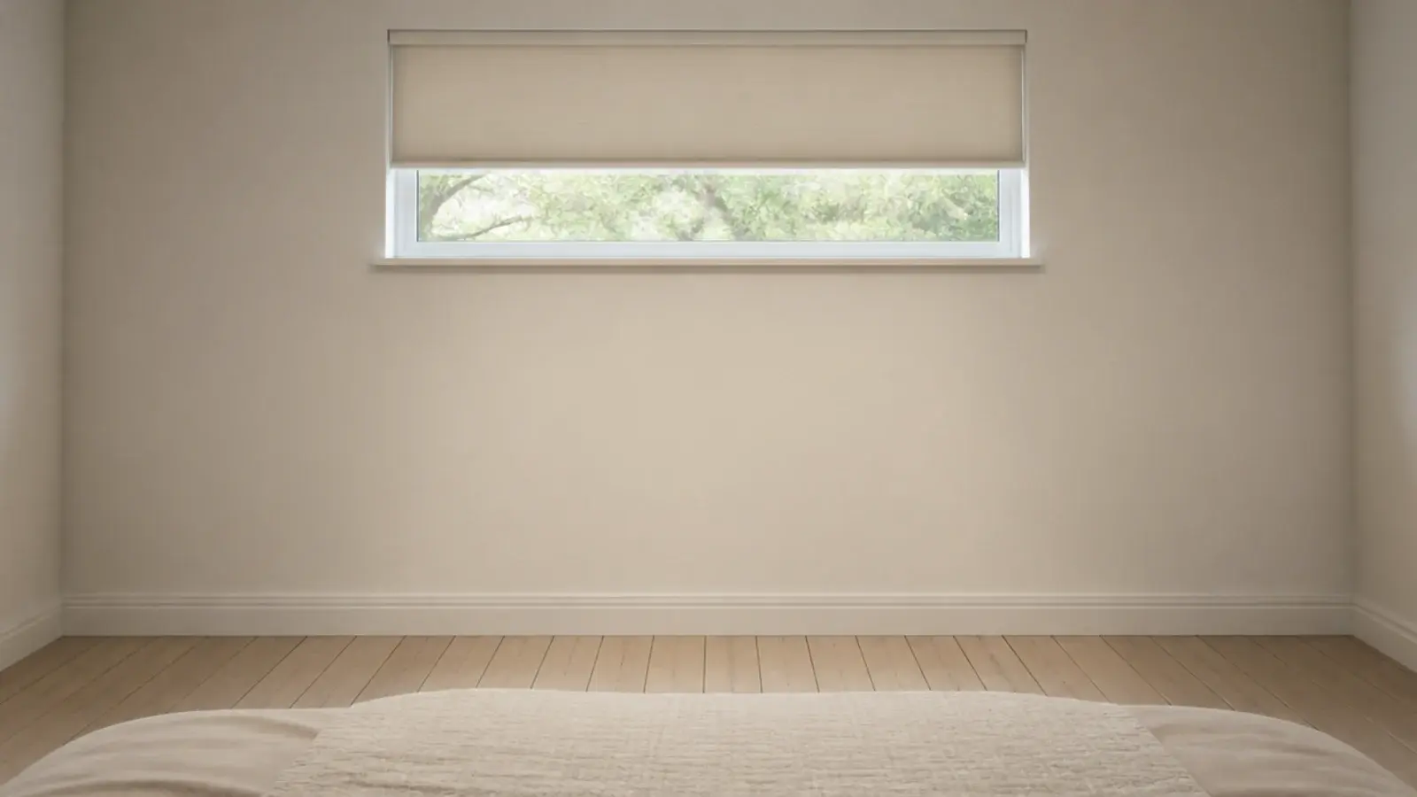 empty wall beneath a bedroom window with no furniture against it
