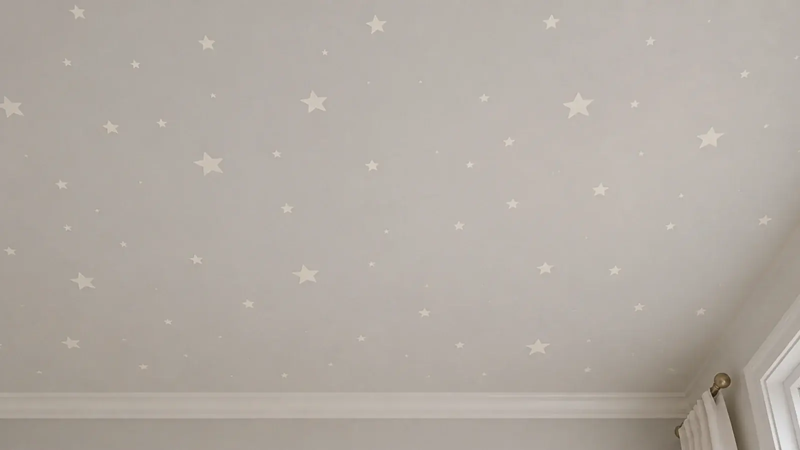 small painted stars scattered across a pale bedroom ceiling
