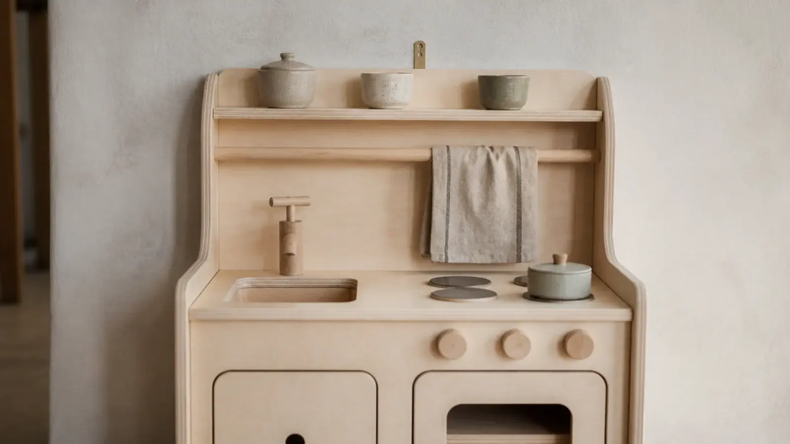 pale birch play kitchen styled with linen cloth and stoneware pots