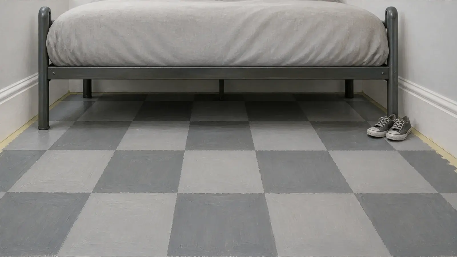 painted checkerboard floor in two pale greys under a child bed