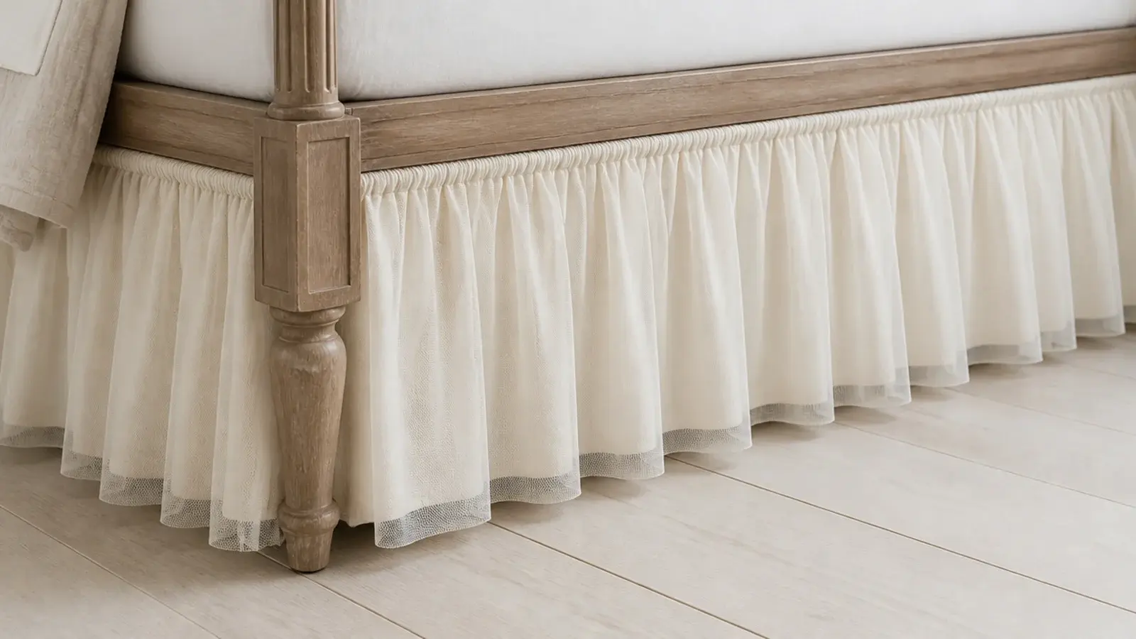 layer of soft tulle gathered along the base of a low bed frame