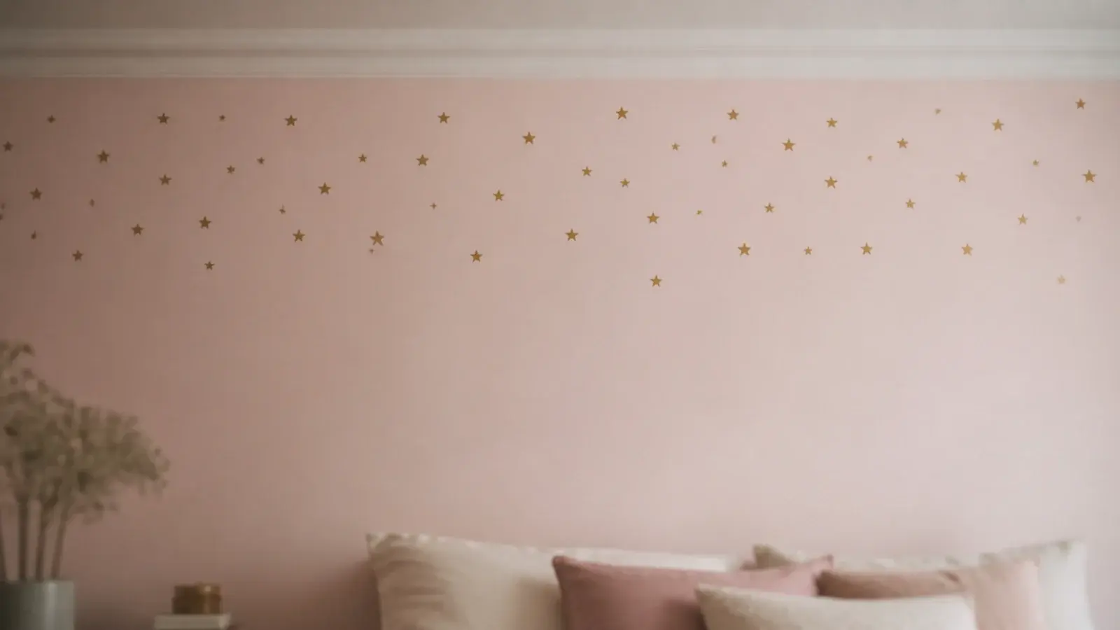 small matte gold star decals scattered high on a bedroom wall