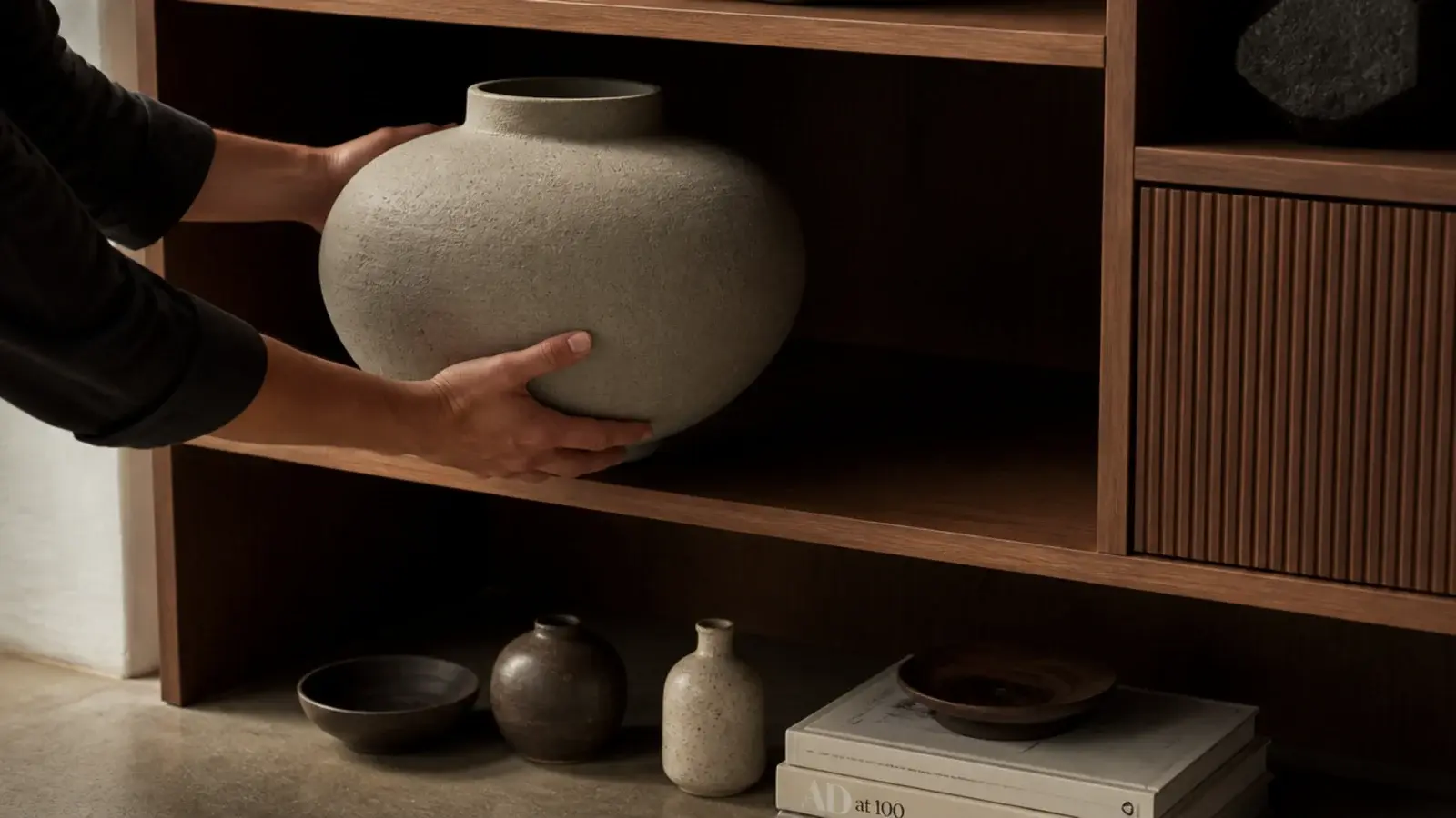 large ceramic vessel positioned in a shelf bay before smaller items