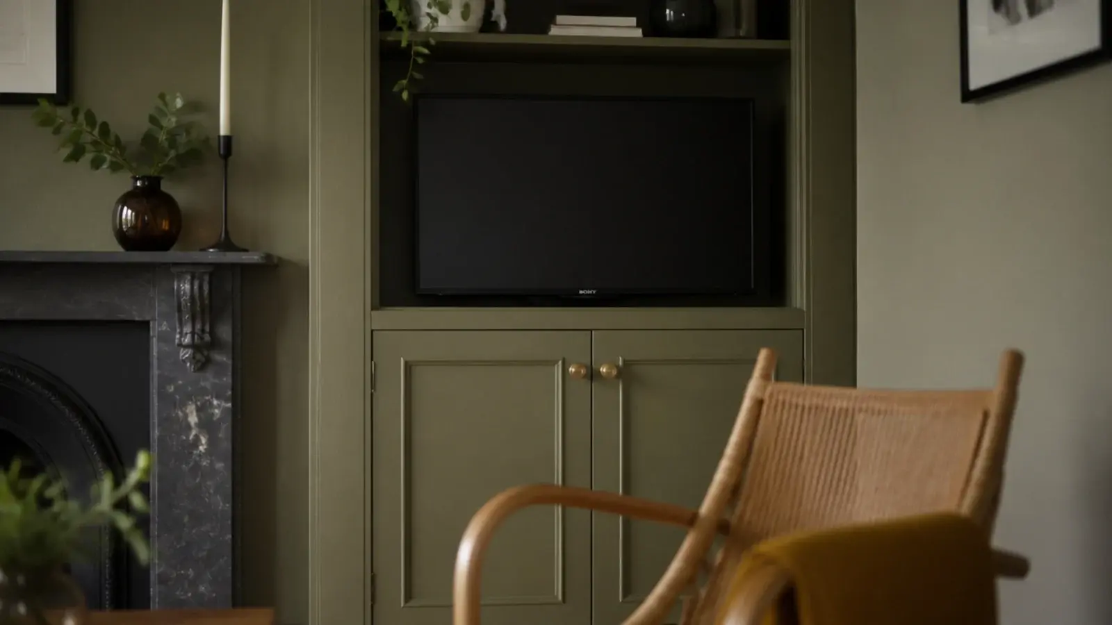 shallow alcove joinery beside a chimney breast holding a compact screen