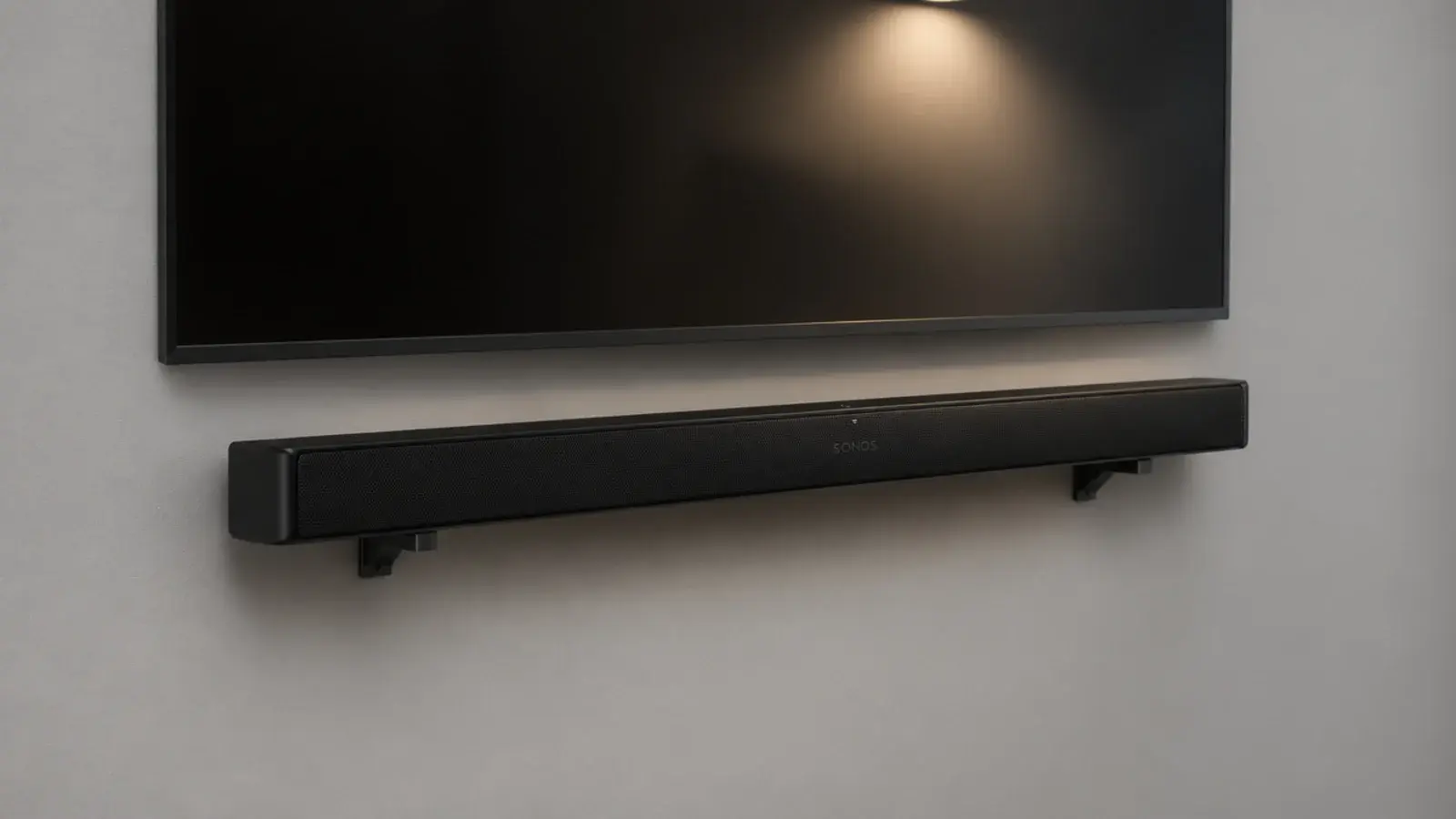 soundbar held on slim wall brackets directly beneath a mounted screen
